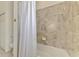 A bathroom features a soaking tub with tiled walls and a shower curtain at 20290 Lagente Cir, Venice, FL 34293