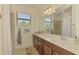 A serene bathroom features a well lit vanity and shower with coastal themed accents at 20290 Lagente Cir, Venice, FL 34293