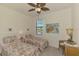 A charming bedroom featuring twin beds with coastal themed decor and a ceiling fan at 20290 Lagente Cir, Venice, FL 34293