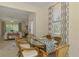Bright dining room with rattan furniture near the living room with natural lighting at 20290 Lagente Cir, Venice, FL 34293