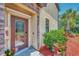 Elegant front entrance with a decorative glass door and well-manicured landscaping at 20290 Lagente Cir, Venice, FL 34293