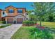 Charming townhome with brick paver driveway, two-car garage, and lush landscaping at 20290 Lagente Cir, Venice, FL 34293