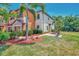 Lovely townhome showcasing tropical landscaping and a private patio area at 20290 Lagente Cir, Venice, FL 34293