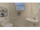 Cozy powder room with a modern sink, toilet, and vibrant artwork at 20290 Lagente Cir, Venice, FL 34293