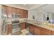 Well-equipped kitchen boasting granite counters, wood cabinets, and stainless steel appliances at 20290 Lagente Cir, Venice, FL 34293