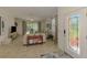 Bright living room with tile flooring, neutral walls, and slider access to the outdoor patio at 20290 Lagente Cir, Venice, FL 34293