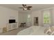A bright main bedroom featuring a television on top of an elegant white cabinet at 20290 Lagente Cir, Venice, FL 34293