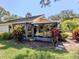 View of screened-in lanai surrounded by landscaping with beautiful colors at 229 Southampton Drive # 290, Venice, FL 34293