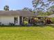 Backyard features a screened in lanai with a landscaped yard and mature trees at 229 Southampton Drive # 290, Venice, FL 34293