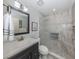 Bathroom features gray vanity, glassed in shower with tile surround, and gray paint at 229 Southampton Drive # 290, Venice, FL 34293