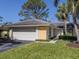 Charming single-story home features a two-car garage, well-manicured lawn, and beautiful mature trees at 229 Southampton Drive # 290, Venice, FL 34293