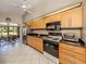 Bright kitchen with granite countertops, stainless steel appliances, and seamless access to an outdoor eating area at 229 Southampton Drive # 290, Venice, FL 34293