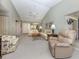 Open living room with a vaulted ceiling flows into the dining area, creating an inviting space at 229 Southampton Drive # 290, Venice, FL 34293