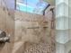 Tiled shower features mosaic tile floors, glass block, grab bar and window for natural light at 229 Southampton Drive # 290, Venice, FL 34293