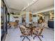 Sunroom with tiled floor and wicker furniture that leads into the kitchen and living room at 229 Southampton Drive # 290, Venice, FL 34293