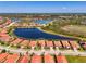 Aerial view of home with terracotta roof, encircled for location, near a lake and community at 23494 Copperleaf Dr, Venice, FL 34293