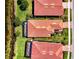 Aerial view of tile roofs with screened in lanai, landscaping and lake at 23494 Copperleaf Dr, Venice, FL 34293