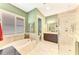 Bathroom features a large soaking tub, vanity, and glass shower at 23494 Copperleaf Dr, Venice, FL 34293