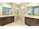 Bathroom featuring double vanity sinks and glass shower at 23494 Copperleaf Dr, Venice, FL 34293