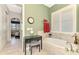 Bathroom features a large soaking tub, vanity, and shutters at 23494 Copperleaf Dr, Venice, FL 34293