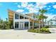 Exterior view of the building featuring a modern design with large windows and palm trees at 23494 Copperleaf Dr, Venice, FL 34293