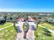 Aerial view of the landscaped entrance featuring the American and Florida flags with water views at 23494 Copperleaf Dr, Venice, FL 34293