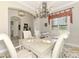Well-appointed dining area with seating for six, a modern chandelier, and access to other rooms at 23494 Copperleaf Dr, Venice, FL 34293