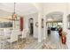 Spacious dining room leading to the kitchen and living areas, featuring tile floors and a modern chandelier at 23494 Copperleaf Dr, Venice, FL 34293