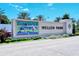 Wellen Park's sign framed by palms and manicured landscaping at 23494 Copperleaf Dr, Venice, FL 34293