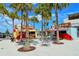 Outdoor food stalls with seating and palm trees, creating a lively and inviting atmosphere at 23494 Copperleaf Dr, Venice, FL 34293