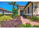 Attractive home with a terracotta roof, a brick paver walkway, and colorful landscaping at 23494 Copperleaf Dr, Venice, FL 34293