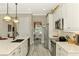 Open kitchen with modern appliances, sleek countertops, and seamless access to the formal dining room at 23494 Copperleaf Dr, Venice, FL 34293