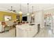 Spacious kitchen island with bar seating provides seamless flow into the sunny living room for entertaining at 23494 Copperleaf Dr, Venice, FL 34293