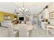 Open concept kitchen with an island, modern appliances, pendant lights, and adjacent living and dining areas at 23494 Copperleaf Dr, Venice, FL 34293