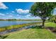 Beautiful lake view from the property, surrounded by well-manicured lawns and mature trees at 23494 Copperleaf Dr, Venice, FL 34293