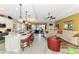 Open-concept living space featuring a kitchen island, living room area, and sliding glass doors to the lanai at 23494 Copperleaf Dr, Venice, FL 34293