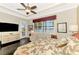 Bright main bedroom features tray ceiling, ceiling fan, large window, and hardwood floors at 23494 Copperleaf Dr, Venice, FL 34293