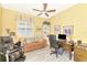 Cozy office space featuring yellow walls, a ceiling fan, comfortable seating, and a functional work desk at 23494 Copperleaf Dr, Venice, FL 34293