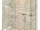 Beautifully tiled walk-in shower with glass door, rainfall shower head, and a built-in soap rack at 23494 Copperleaf Dr, Venice, FL 34293