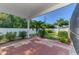 Outdoor patio area features brick pavers, privacy fence, and well-manicured landscaping at 23516 Peachland Blvd, Port Charlotte, FL 33954