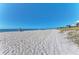 Wide expanse of white sandy beach with blue skies, perfect for a relaxing day at 23516 Peachland Blvd, Port Charlotte, FL 33954