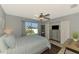 Well-lit bedroom with ceiling fan, closet, and window view at 23516 Peachland Blvd, Port Charlotte, FL 33954