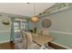 Dining area with stylish light fixture, hardwood floors and light colors, perfect for everyday meals and entertaining at 23516 Peachland Blvd, Port Charlotte, FL 33954