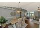 Dining area with elegant light fixture, hardwood floors, and seamless flow into the living area and kitchen at 23516 Peachland Blvd, Port Charlotte, FL 33954