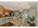 Dining area with breakfast bar and view of pool through sliding doors, ideal for entertaining and relaxed living at 23516 Peachland Blvd, Port Charlotte, FL 33954