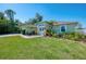 Well maintained single-story home with lush green lawn and mature landscaping at 23516 Peachland Blvd, Port Charlotte, FL 33954
