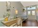 Foyer with decorative mirror and console table adjacent to the front entry at 23516 Peachland Blvd, Port Charlotte, FL 33954