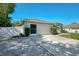 Exterior of home featuring a 2-car garage and verdant shrubbery at 23516 Peachland Blvd, Port Charlotte, FL 33954
