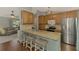 Kitchen featuring stainless steel appliances, granite countertops, breakfast bar, and hardwood flooring at 23516 Peachland Blvd, Port Charlotte, FL 33954