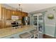 Well-appointed kitchen with breakfast bar, stainless steel appliances, granite countertops, and hardwood flooring at 23516 Peachland Blvd, Port Charlotte, FL 33954